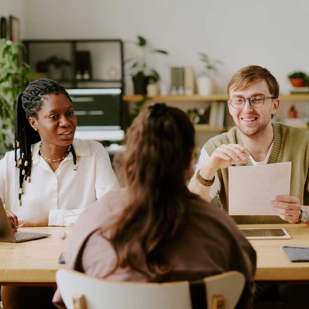Smiling Hiring Managers Talking to Unrecognizable Applicant
